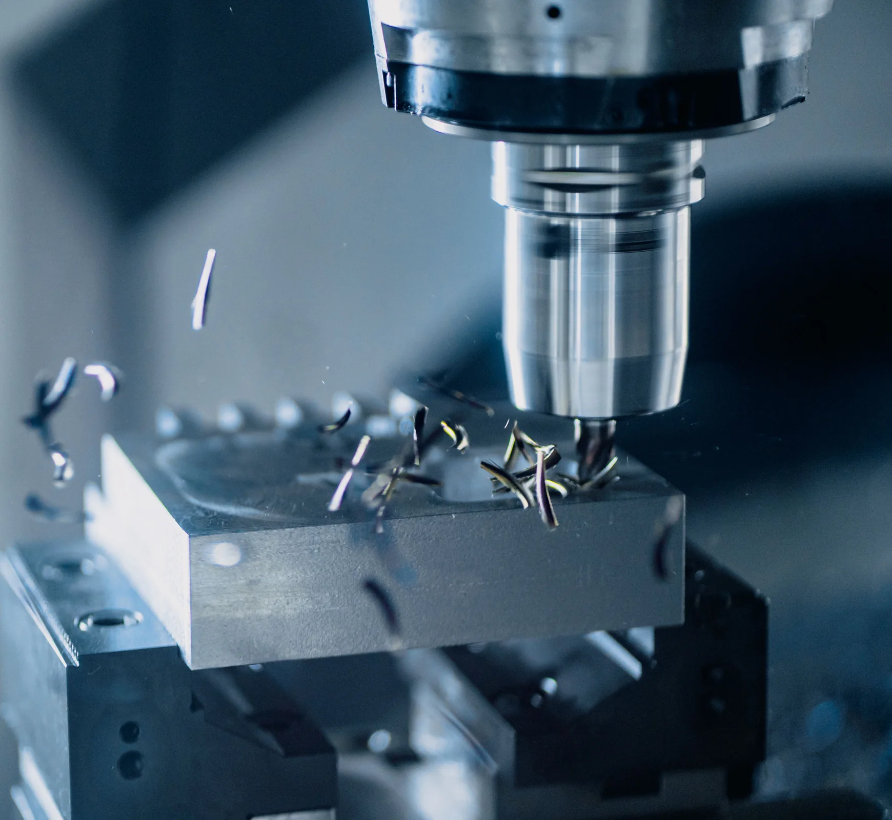 CNC milling a metal workpiece; representative tooling process photograph