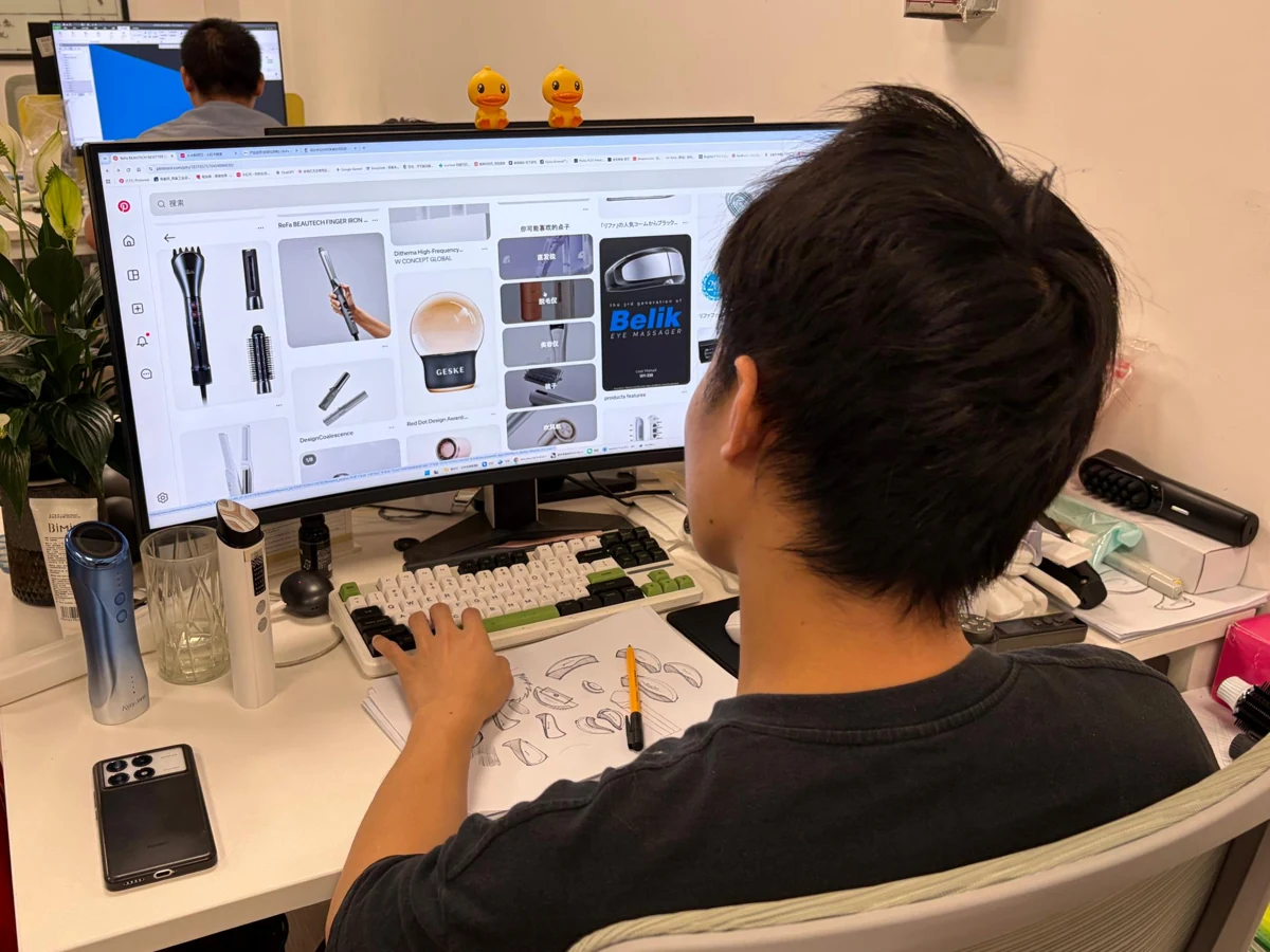 Designer working with product sketches, references and device samples