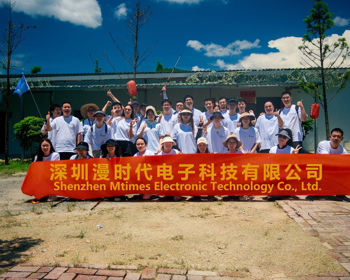 The Mtimes team holding the company banner at the 2024 mountain expedition