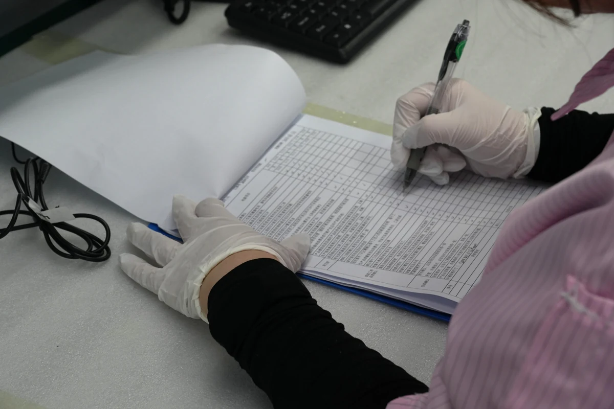 Quality team member documenting inspection results on a check sheet